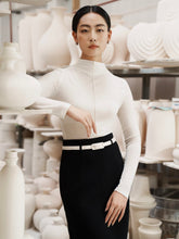 Fitted wool-blend turtleneck top with long sleeves and clean front seam detail